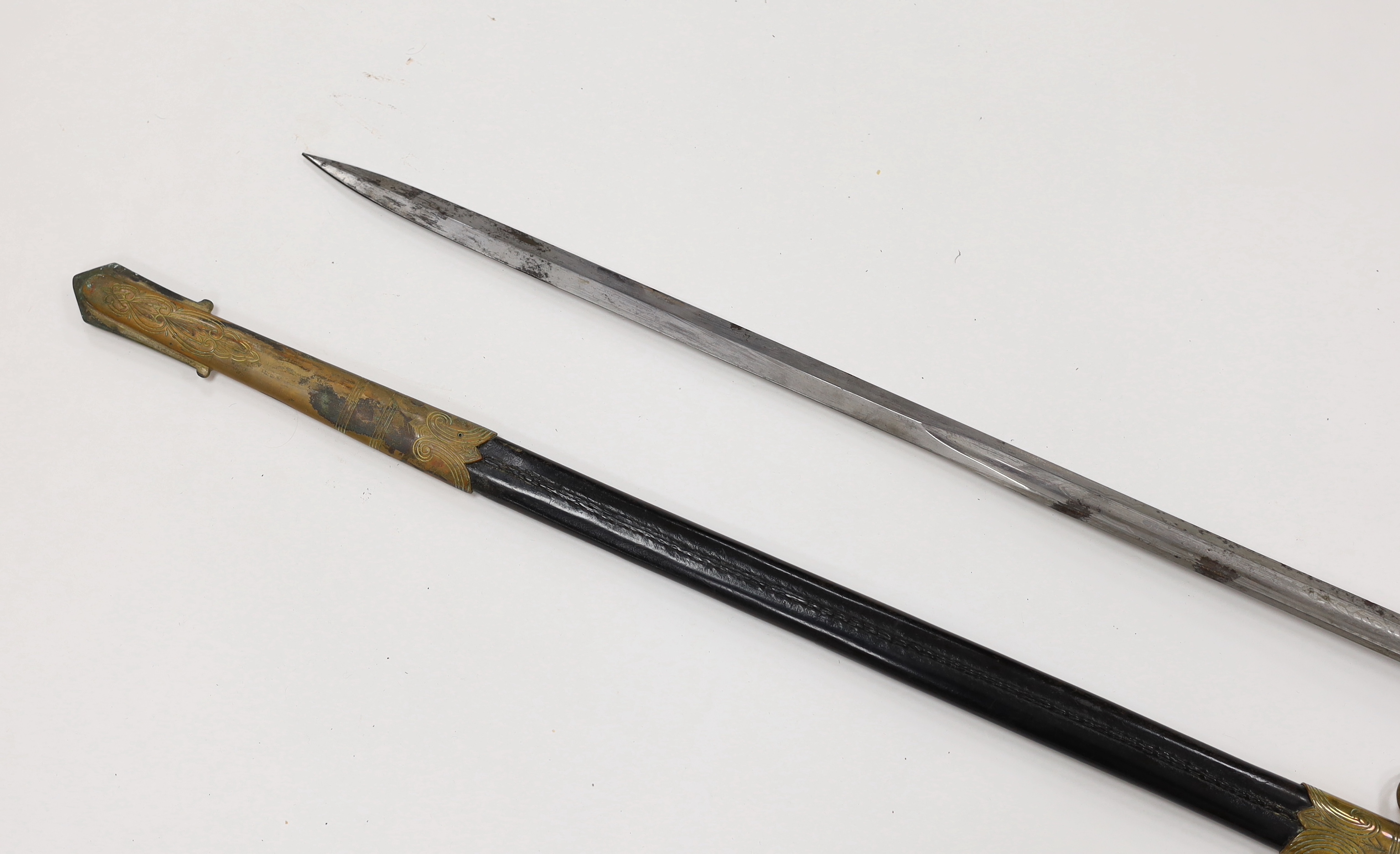 A George V naval officer’s sword, maker Grieves, in a leather scabbard, guard engraved G.P. Bewley, blade 79.5cm, together with outer leather cover